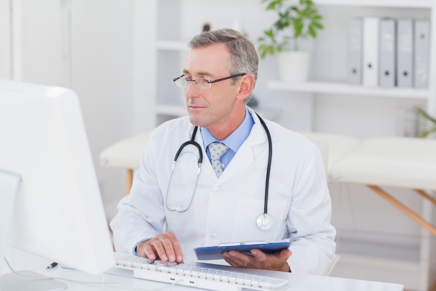 doctor by computer with pointclickcare program